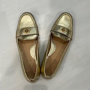 Gold tone Coach shoe